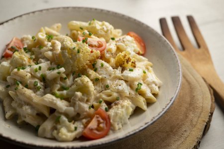 Photo for Macaroni cooked with cream, cheese and baked cauliflower. - Royalty Free Image