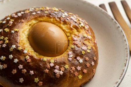 Photo for Mona de Pascua, sponge cake with boiled egg. Traditional Spanish dessert for Holy Week - Royalty Free Image