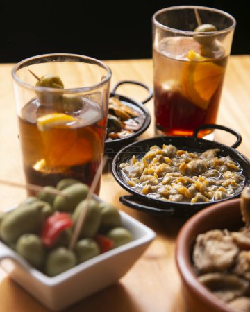 Table with Spanish tapas and vermouth at noon in a bar in Barcelona.