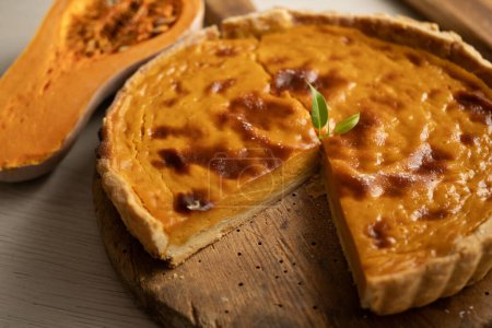 Photo for American pumpkin pie cooked with cinnamon and other spices. Special fall and halloween recipe. - Royalty Free Image