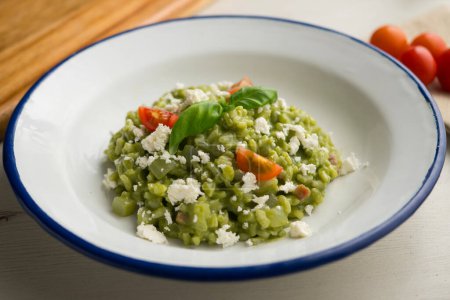 Creamy Italian risotto with spinach and cheese. Traditional Italian recipe.