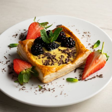 Photo for Puff pastry dessert with strawberries and blackberries filled with pastry cream. - Royalty Free Image