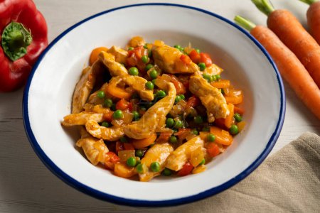 Photo for Chicken strips sauted with peppers, peas, onion and carrot. - Royalty Free Image