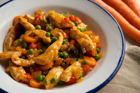 Photo for Chicken strips sauted with peppers, peas, onion and carrot. - Royalty Free Image