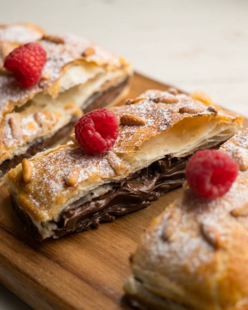 Photo for Chocolate San Juan Coca. Traditional San Juan cake to celebrate the arrival of summer in Spain made with puff pastry and cocoa cream. - Royalty Free Image