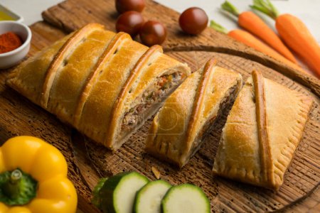 Photo for Traditional Galician empanada filled with vegetables and anchovies. Traditional recipe from the northern part of Spain. - Royalty Free Image