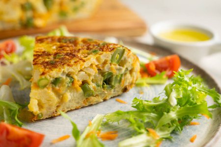 Photo for Spanish potato omelet with cauliflower and vegetables. Traditional Spanish tapa recipe. - Royalty Free Image