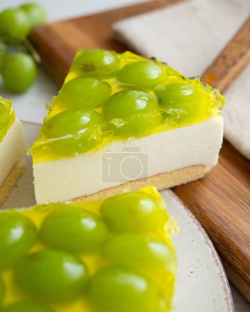 Photo for Cheesecake with grapes on a sponge cake base. - Royalty Free Image
