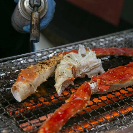 Photo for King crab legs cooked on a barbecue in the city of Osaka in Japan. - Royalty Free Image