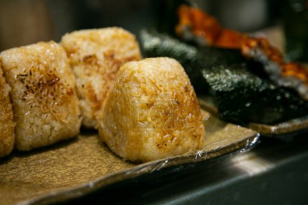 Foto de Yaki Onigiri son bolas de arroz japonesas que se asan a la parrilla y glaseado en salsa de soja salada. - Imagen libre de derechos