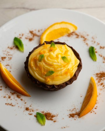 Chocolate tartlets with orange cream.