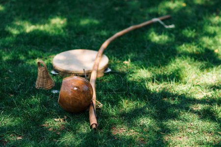 Photo for Close up view of brazilian musical instrument berimbau on a green grass in nature - Royalty Free Image