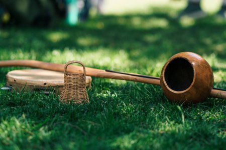 Photo for Close up view of brazilian musical instrument berimbau on a green grass in nature - Royalty Free Image