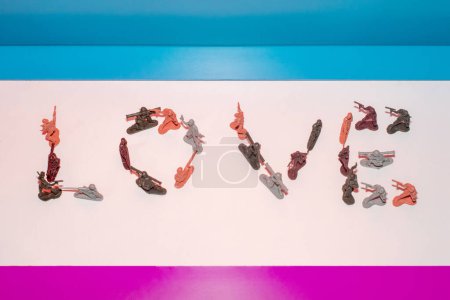 Word LOVE made from toy army soldiers. Creative concept. 