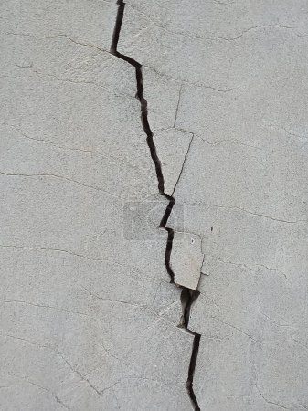 Photo for Close up vertical cracked on gray concrete wall. For background. No people. - Royalty Free Image