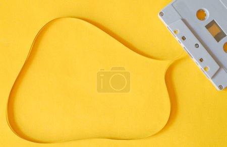 Photo for Top view photography of old plastic cassette with copy space magnetic tape on isolated yellow background. - Royalty Free Image