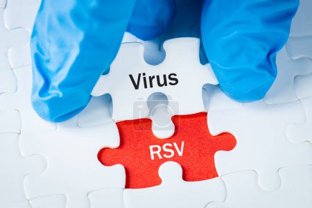 Photo for RSV virus "respiratory syncytial virus" Health concept, Dangerous disease for children, Flu season, Inscription on puzzle pieces held in doctor's hands - Royalty Free Image