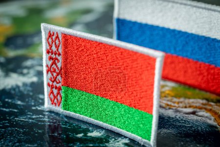 Foto de The flag of Belarus and the flag of Russia in the background, concept, Mutual relations of the two countries, Economic dependence of Belarus - Imagen libre de derechos