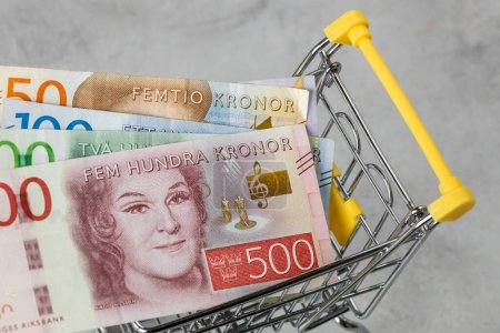 Photo for Financial concept, Inflation rate in Sweden, prices in stores, Empty shopping cart and Swedish krona - Royalty Free Image