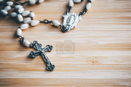 Rosary lying on the table, Catholic cross-stock-photo
