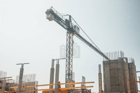 Foto de Planta de construcción, grúa elevándose por encima del edificio en construcción, Construcción continuando - Imagen libre de derechos