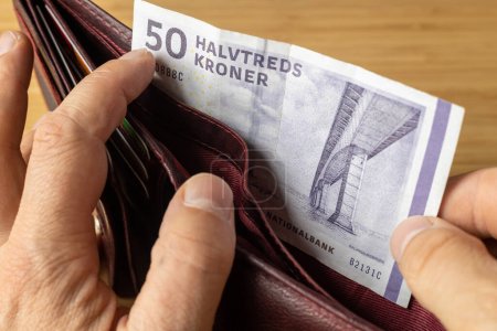 Denmark Money, 50 danish kroner banknote taken out of wallet, Financial and business concept, close up