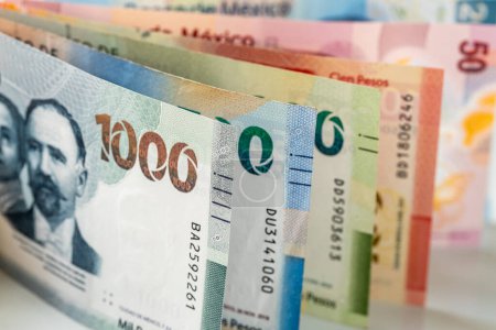 Mexico money, mexican pesos, stacked various banknotes, 1000 pesos banknote, financial business concep