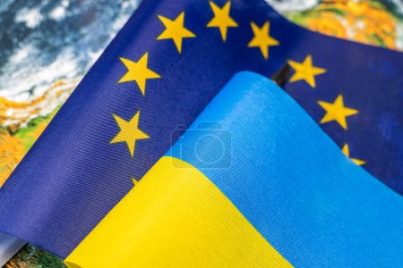 Flags of the European Union and Ukraine against the background of the globe, Economic and political concept, Cooperation and mutual relations, Ukraine desire to join the European Union