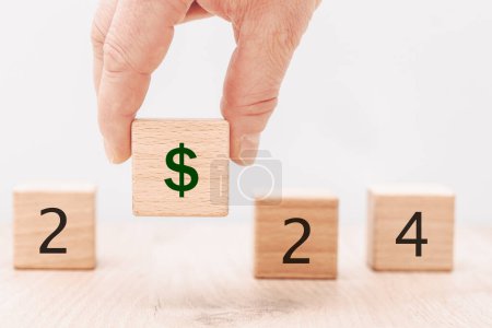 Photo for Year 2024, business concept. Dollar sign on the wooden cube, Economic and financial analysis, interest rates, stocks, bonds, ranking, mortgage, loan rates, Percent - Royalty Free Image