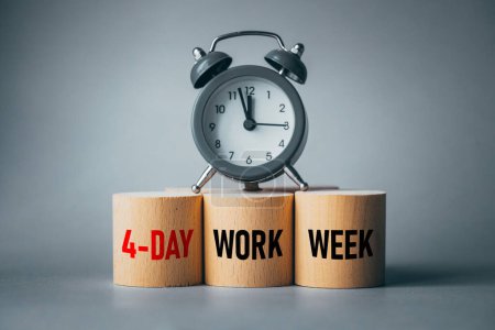 Photo for Symbol of a 4-day working week. Desk with wooden blocks with the words 4-day work week, alarm clock and beautiful gray background. Copy space. Business concept, change from 5 to 4 day work week - Royalty Free Image