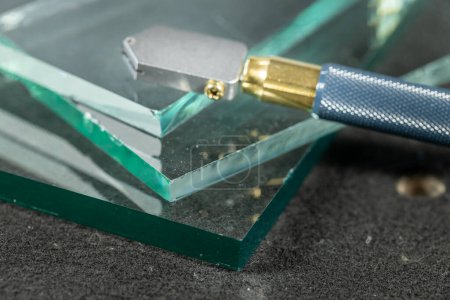 Glass cutting tool lying on the glass, Work and tools of a glazier