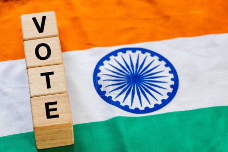 Foto de India Vote, Concept, Word Vote escrito en bloques de madera dentro de la bandera india, de cerca - Imagen libre de derechos