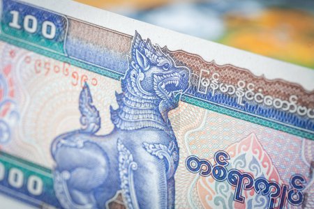 Myanmar money, 100 Birmania kyat banknote against the background of the world, financial market concept