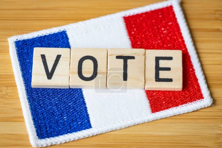 Voting in France. The flag of France and wooden blocks with the word Vote