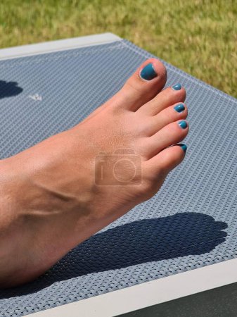 Photo for Close-up of women's feet on a summer lounger. High quality photo - Royalty Free Image