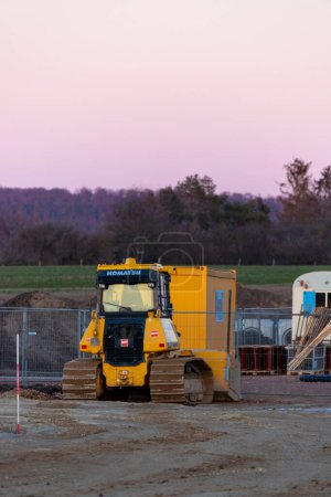 Photo for Bulldozer from behind, standing on a mineral mixture construction site. High quality photo - Royalty Free Image