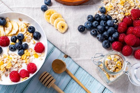 Foto de Tasty meal with yoghurt, banana, berries and cereals - Imagen libre de derechos