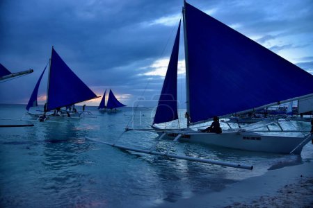 Photo for Beautiful orange tropical sunset with sailboats at Philippines - Royalty Free Image
