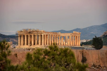 Photo for Parthenon temple at sunset Acropolis in Athens, Greece. The Parthenon is a temple on the Athenian Acropolis in Greece, dedicated to the goddess Athena. - Royalty Free Image
