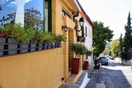 Photo for Athens, Greece, October 18, 2021: View of houses at the narrow street of the Plaka district in Athens, Greece. - Royalty Free Image