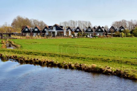 Photo for Amsterdam, Netherlands - April 7, 2023: view of Amsterdam city suburb with typical Holland houses - Royalty Free Image