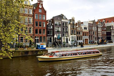 Photo for Amsterdam, Netherlands - April 7, 2023: Beautiful view of Amsterdam canals surrounded by colorful houses - Royalty Free Image