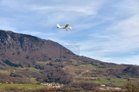 Photo for Chatillon-en-Michaille, France - 23 March, 2023: white plane flying near mountains at Rhone-Alps, France - Royalty Free Image