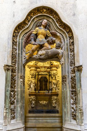 the stone door of the chapel with an angel above it