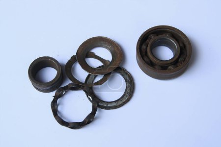 Photo for Old rusty bearing on white background. Old broken bearings rusted and disassembled into many parts. Old rust iron ball bearing disintegrated. Close-up view - Royalty Free Image