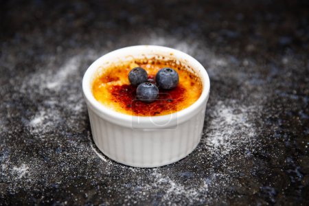 Photo for Traditional creme brule on rustic surface and selective focus - Royalty Free Image