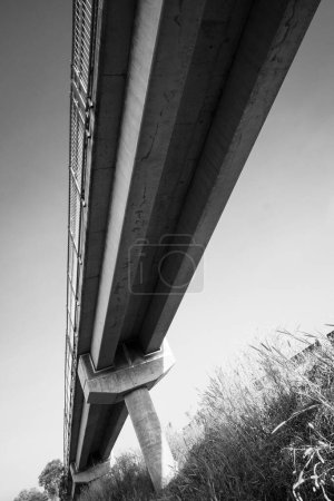Photo for A low-angle photograph from underneath the pedestrian overpass at Yarrawonga, Palmerston, Northern Territory highlighting engineering and design elements indicating structural strength - Royalty Free Image