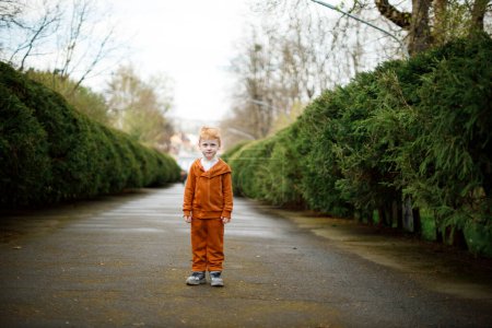A 5-year-old Ukrainian boy walks in a park in a suit