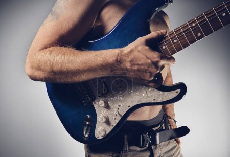 Photo for Guitar player holding guitar in hand - Royalty Free Image