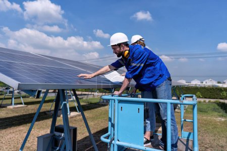 Foto de Ingenieros de mantenimiento en el puesto de granja solar en el elevador de tijera, inspección rutinaria de la condición paneles solares - Imagen libre de derechos